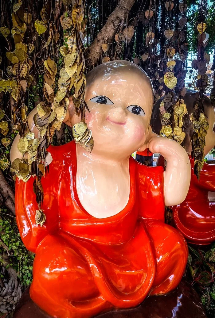 buddha surrounded by gold leaves