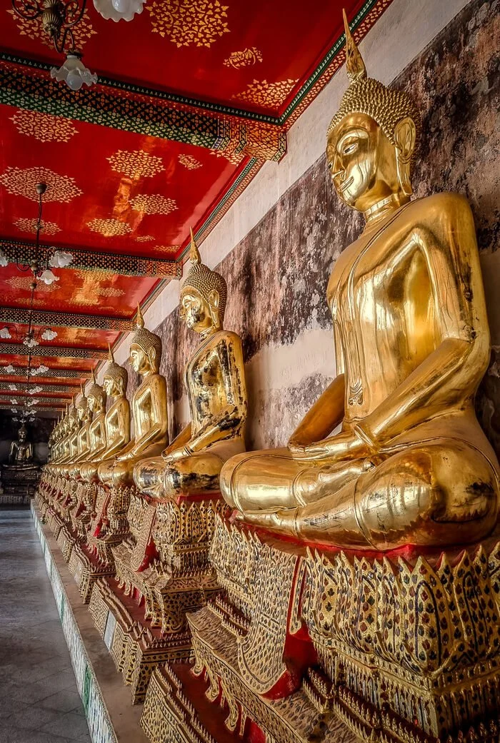 golden buddha statues at a temple in thailand